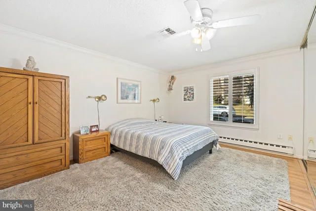 a bedroom with a bed dresser and a window