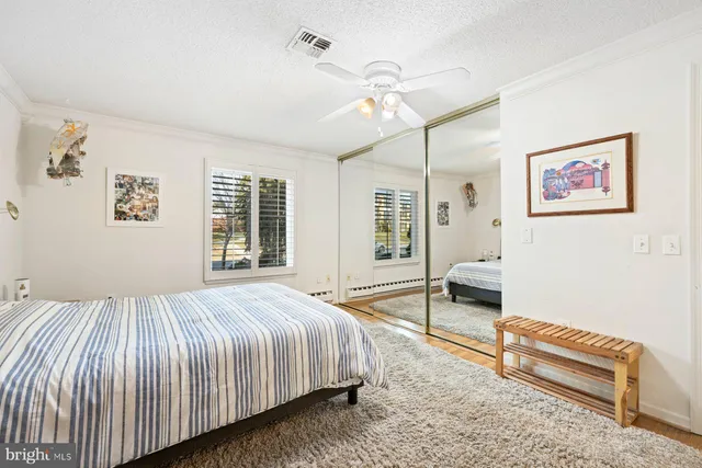 a bed room with a bed and a chair