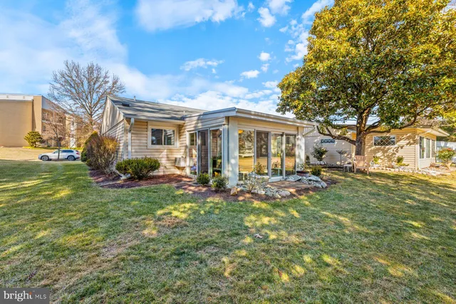 a view of a house with backyard sitting area and garden