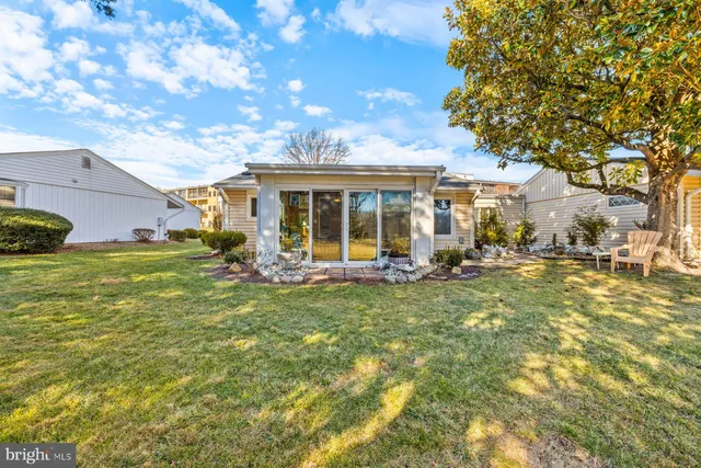 a view of a house with backyard porch and sitting area