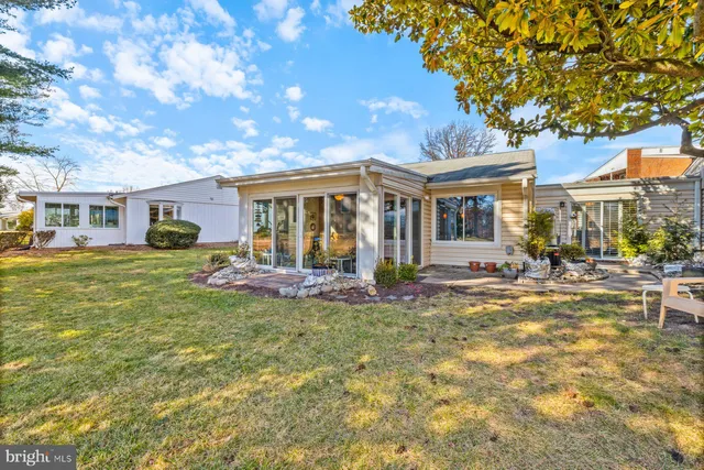 a view of a house with swimming pool and sitting area