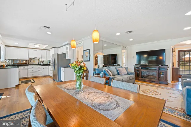 a living room with furniture fireplace and dining table