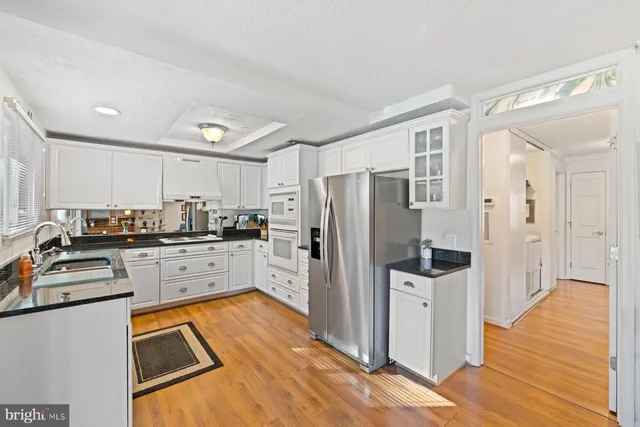 a kitchen with stainless steel appliances a refrigerator sink and stove