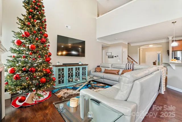 a living room with furniture and a christmas tree