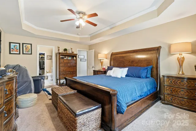 a bedroom with a bed and a chandelier