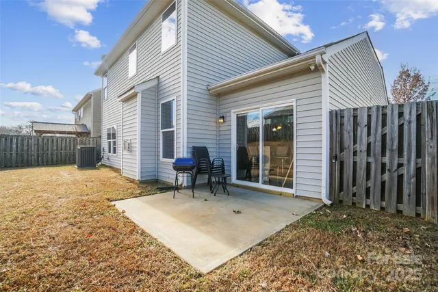 a backyard of a house with table and chairs
