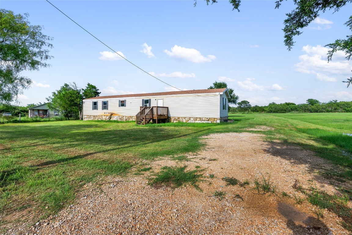 Back of property with a lawn