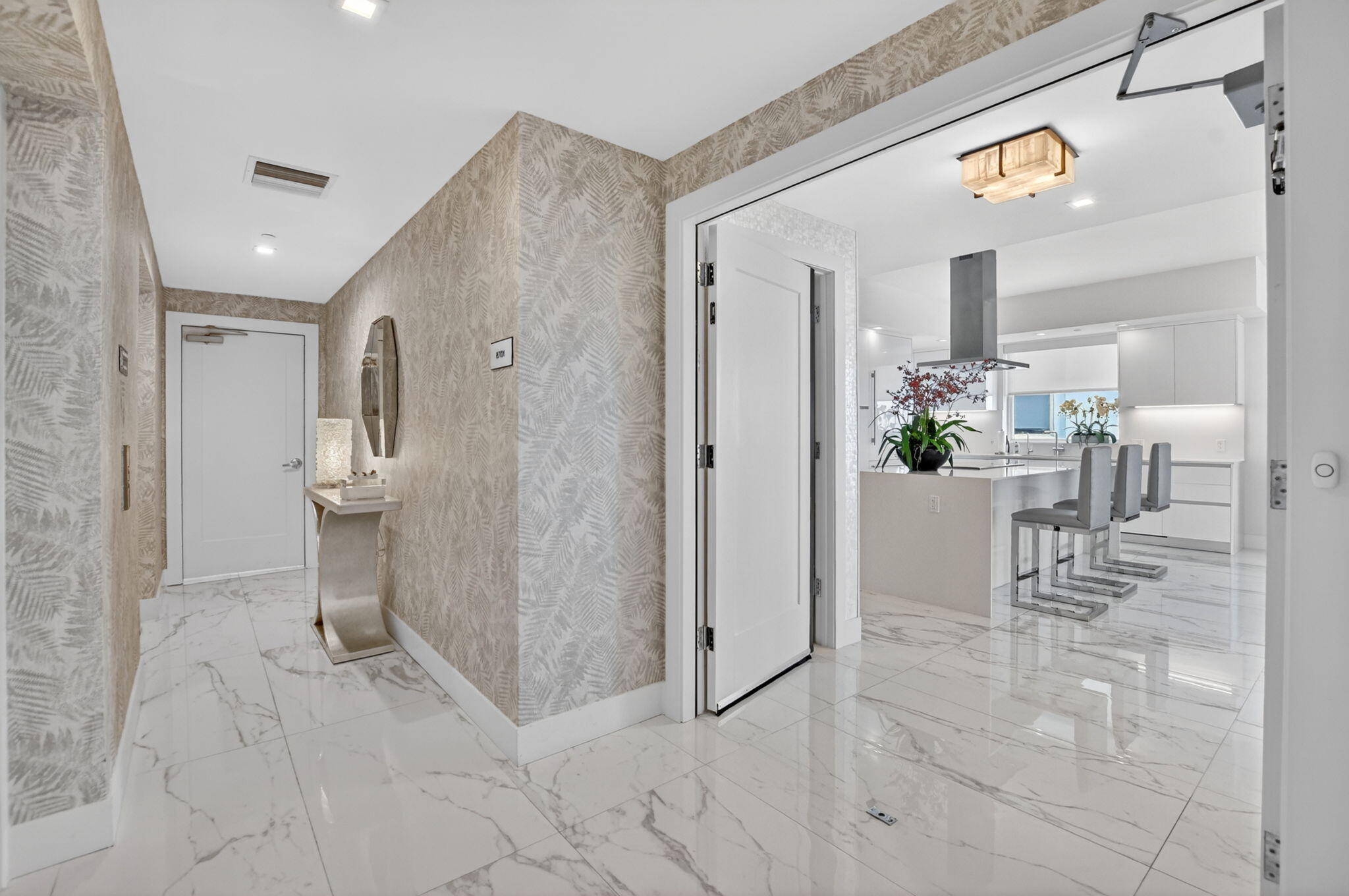 20155 Boca W Drive, Unit B701 Boca Raton, FL 33434 - Photo 6 of 78 a view of a hallway with dining table and chairs