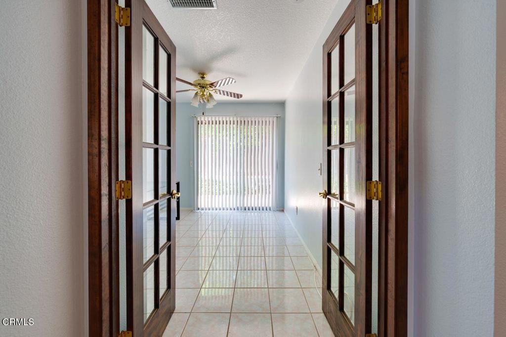 8541 Creekside Place Rancho Cucamonga, CA 91730 - Photo 10 of 18 a view of a hallway with wooden floor and staircase