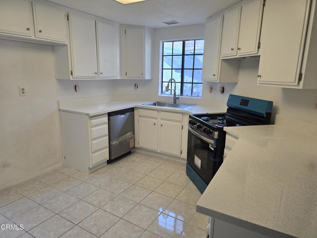 8541 Creekside Place Rancho Cucamonga, CA 91730 - Photo 12 of 18 a kitchen with stainless steel appliances a stove a sink and a refrigerator