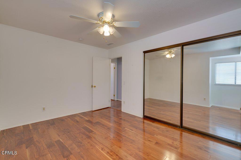 8541 Creekside Place Rancho Cucamonga, CA 91730 - Photo 15 of 18 an empty room with wooden floor and fan
