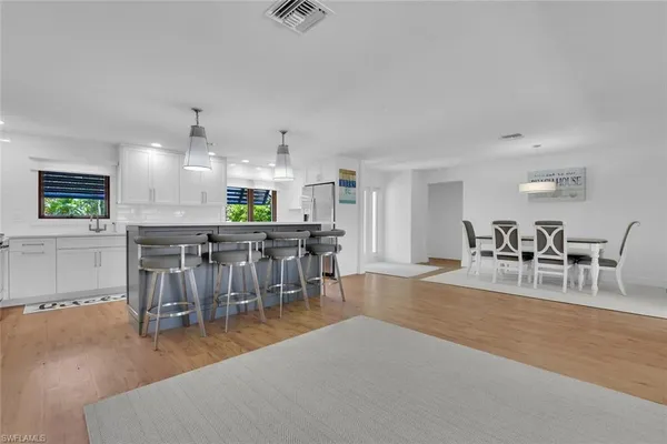 a view of a dining room with furniture kitchen and a chandelier