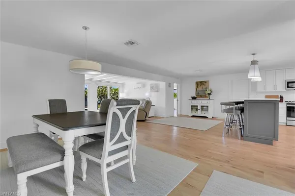 a dining room with furniture and wooden floor