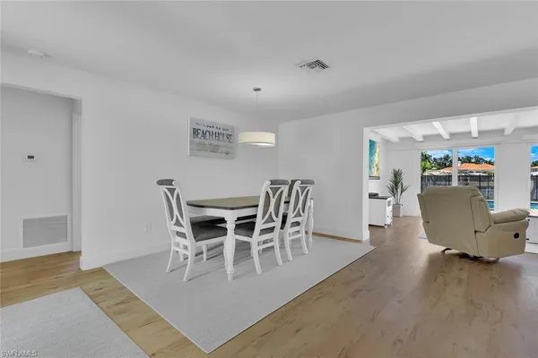 a view of a dining room with furniture and wooden floor