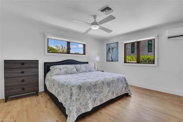 a bedroom with a bed and a painting on the wall