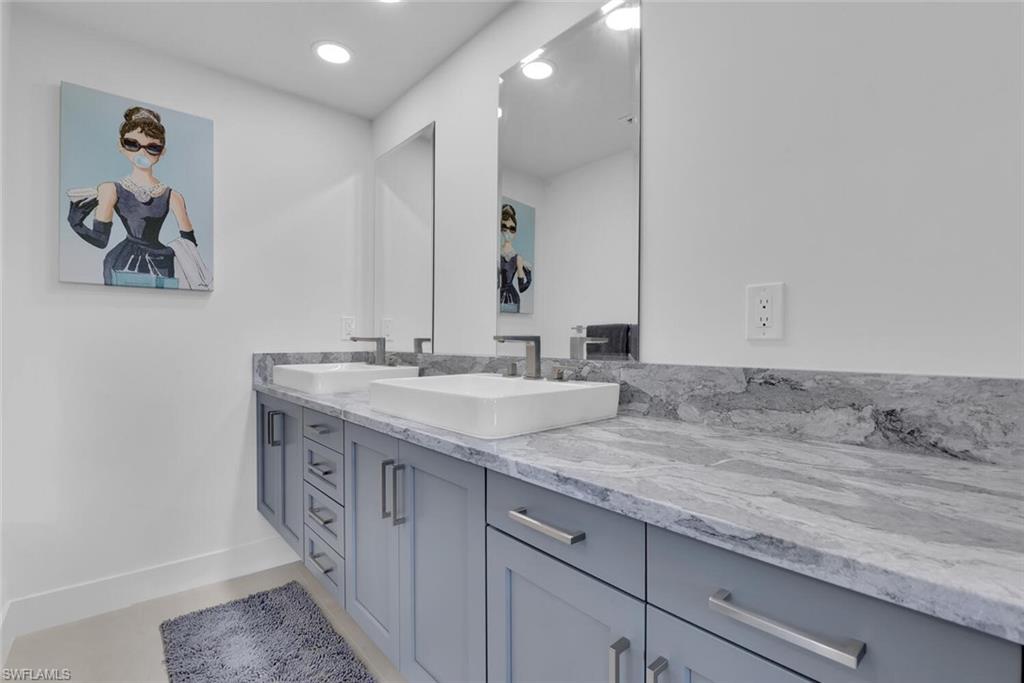 367 Mooring Line Drive Naples, FL 34102 - Photo 16 of 44 a bathroom with a granite countertop sink and a mirror