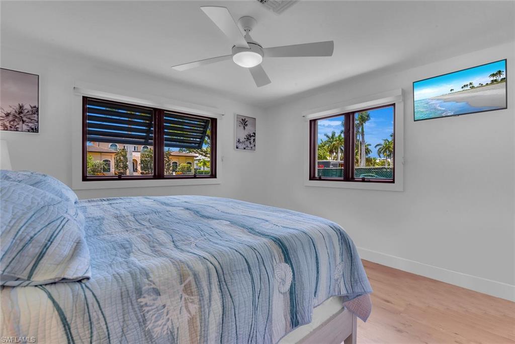 367 Mooring Line Drive Naples, FL 34102 - Photo 18 of 44 a bedroom with a bed and a large window