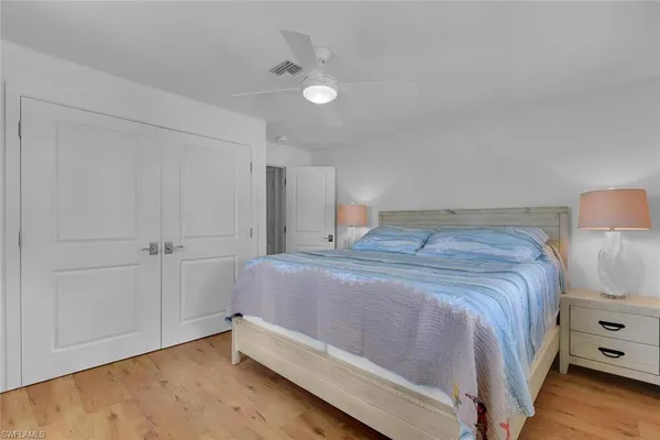 a bedroom with a bed and a night stand