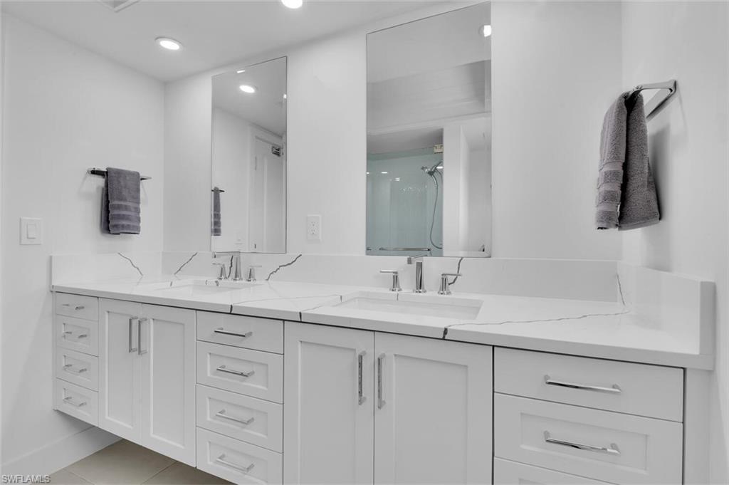 367 Mooring Line Drive Naples, FL 34102 - Photo 20 of 44 a bathroom with a sink and a mirror