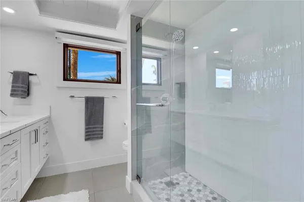 a bathroom with a sink a mirror and a shower