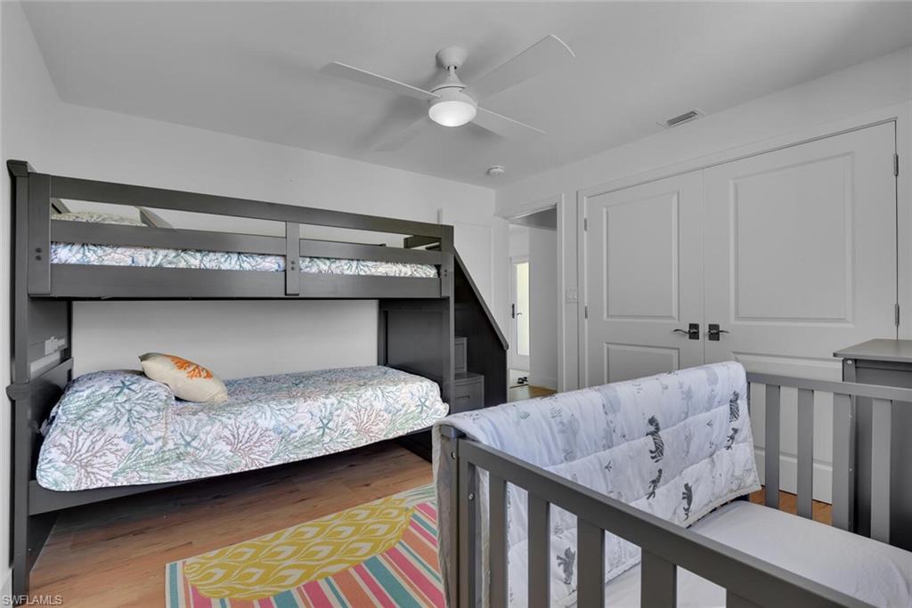 367 Mooring Line Drive Naples, FL 34102 - Photo 22 of 44 a bedroom with a bed and a ceiling fan