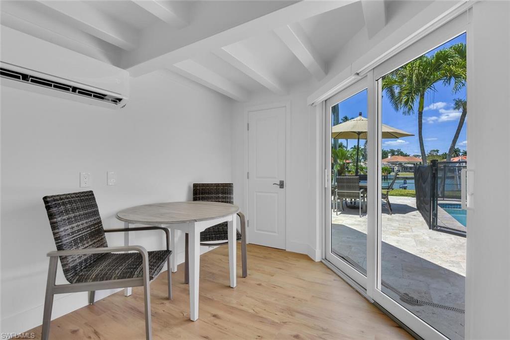367 Mooring Line Drive Naples, FL 34102 - Photo 27 of 44 a view of a dining room with furniture window and wooden floor