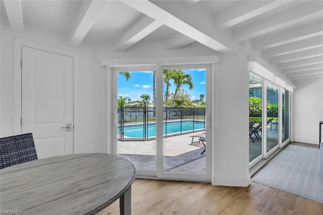 a room with a bed and glass door