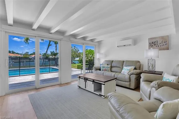 a living room with furniture and large windows