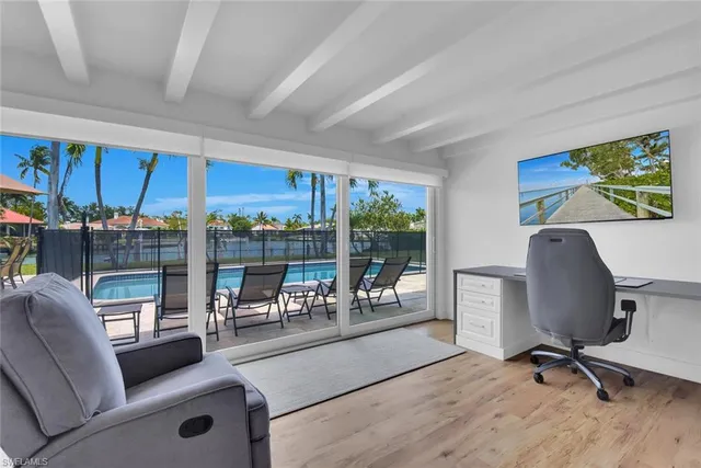 a work room with furniture and a floor to ceiling window