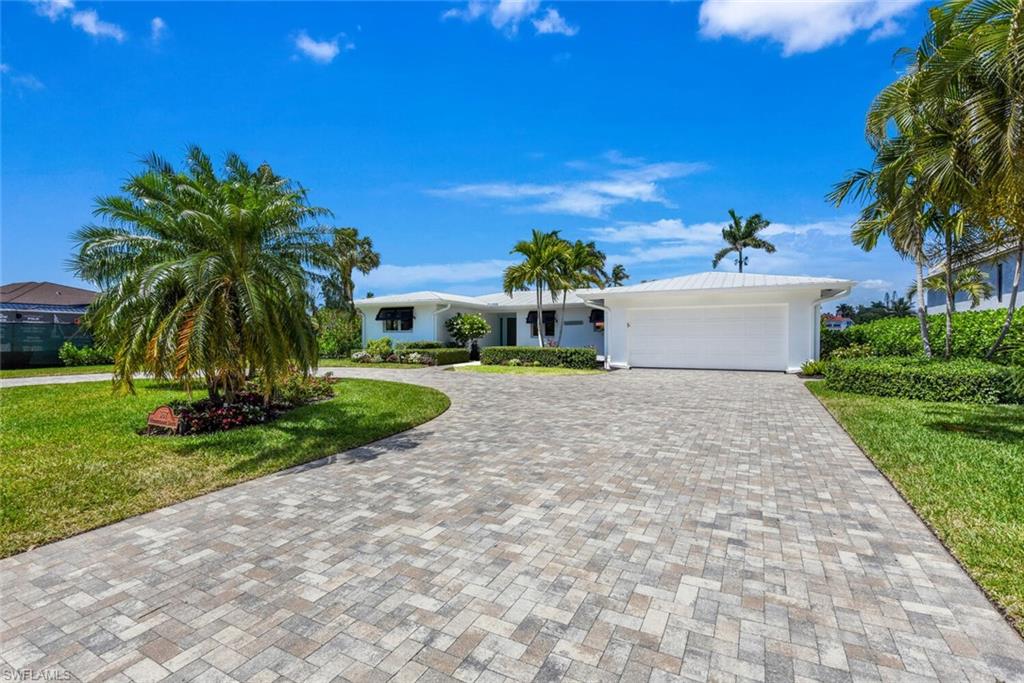367 Mooring Line Drive Naples, FL 34102 - Photo 34 of 44 a front view of a house with a yard