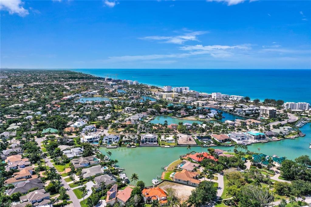 367 Mooring Line Drive Naples, FL 34102 - Photo 44 of 44 an aerial view of a city with lots of residential buildings ocean and mountain view in back