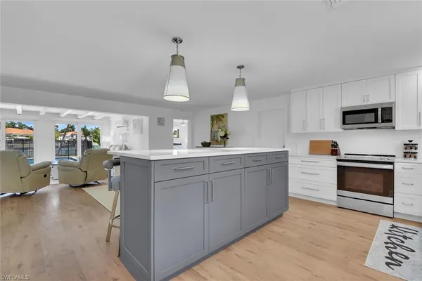 a kitchen with cabinets and window