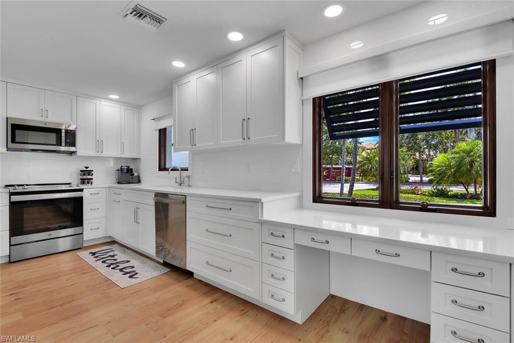 367 Mooring Line Drive Naples, FL 34102 - Photo 9 of 44 a kitchen with stainless steel appliances a stove sink and microwave