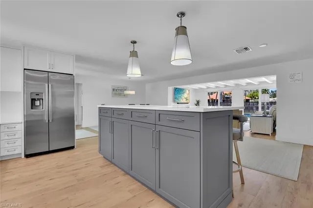 a kitchen with stainless steel appliances a sink and refrigerator