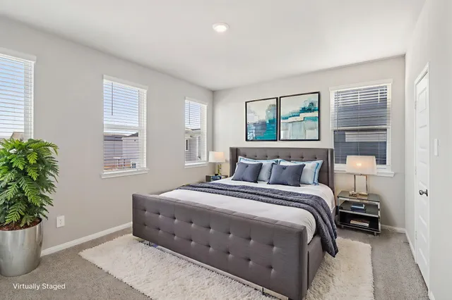 a bedroom with a bed and a potted plant