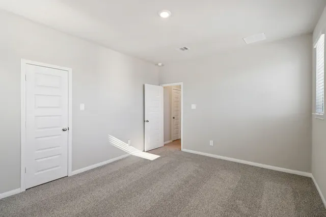 an empty room with closet area