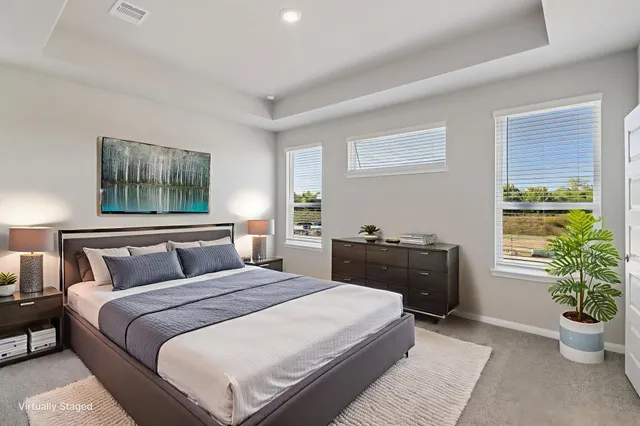 a bedroom with a bed and a potted plant