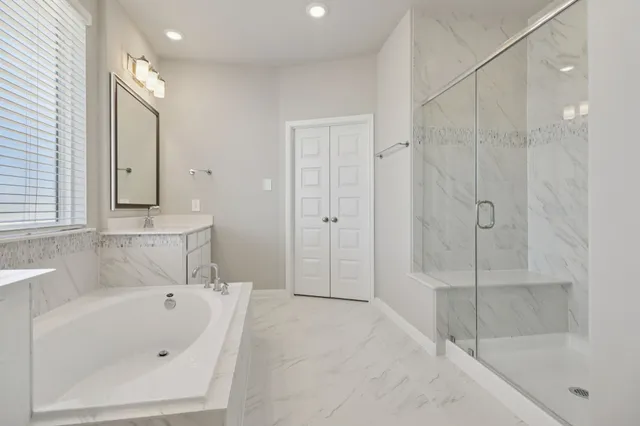 a bathroom with a bathtub and a shower