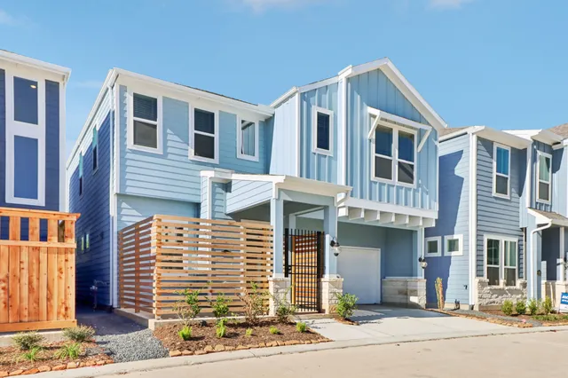 a front view of a house with a road