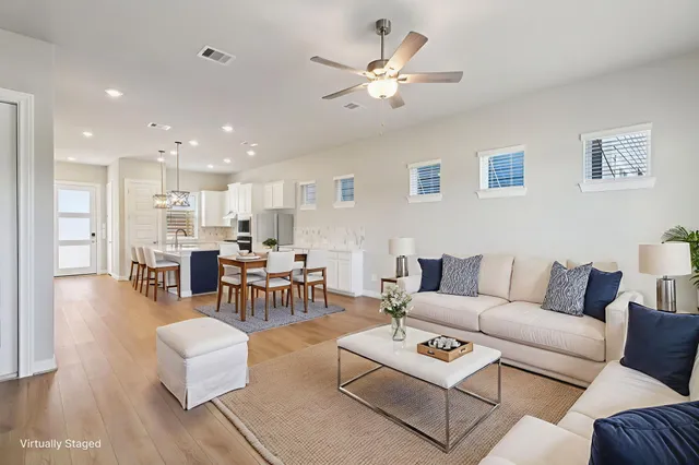 a living room with furniture kitchen view and a table