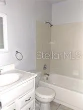 a front view of a house with yard and parking