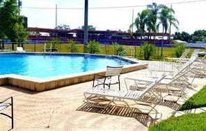 a view of a balcony with wooden floor and fence
