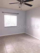 a view of an empty kitchen and a window