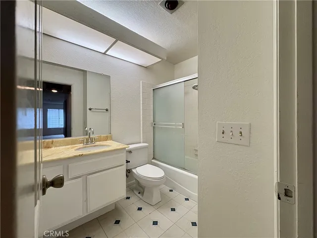 an empty room with windows and cabinet