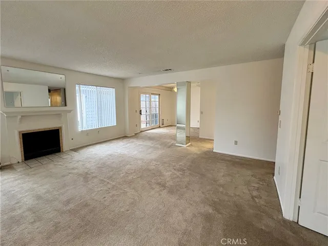 a view of empty room with a fireplace