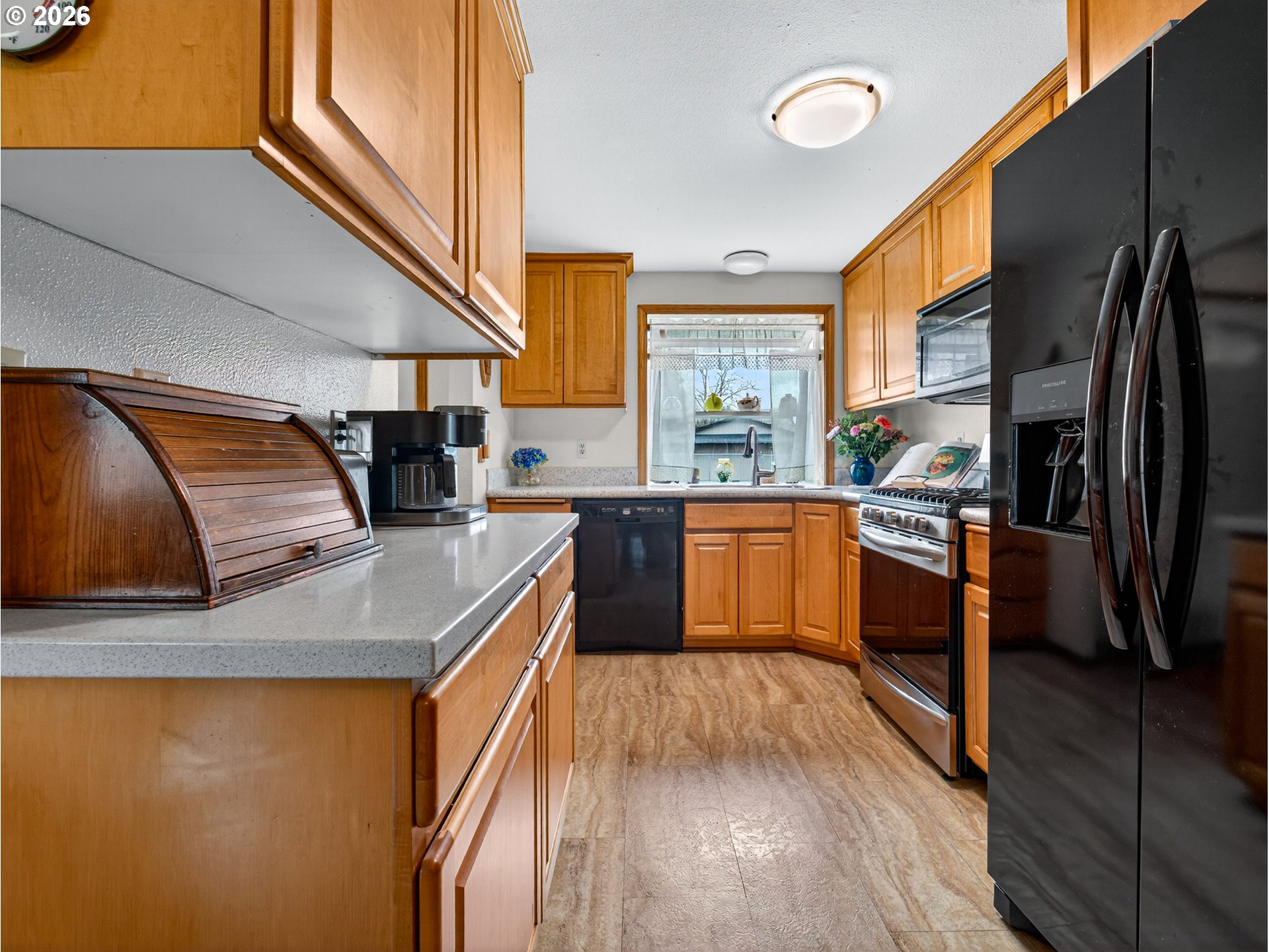 3025 Northeast 29th Street Gresham, OR 97030 - Photo 12 of 33 a kitchen with stainless steel appliances granite countertop a sink a stove and a refrigerator