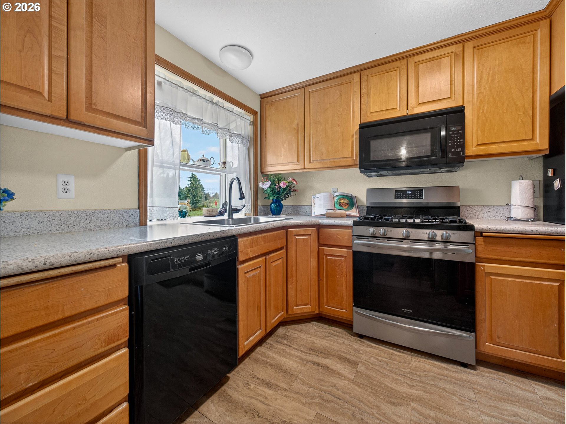 3025 Northeast 29th Street Gresham, OR 97030 - Photo 8 of 33 a kitchen with stainless steel appliances granite countertop a stove a sink dishwasher and a microwave oven with cabinets