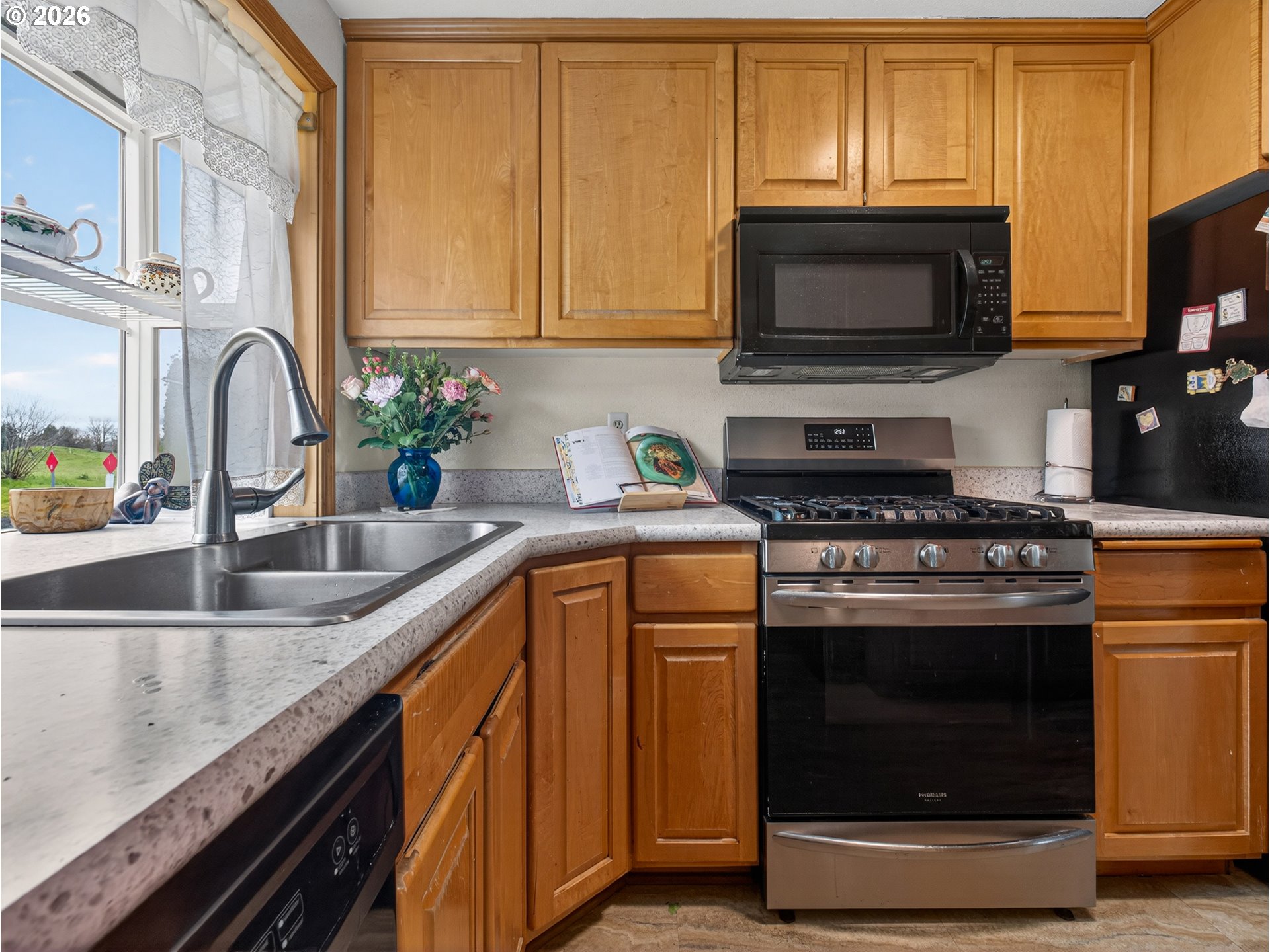 3025 Northeast 29th Street Gresham, OR 97030 - Photo 9 of 33 a kitchen with stainless steel appliances granite countertop a sink stove and microwave