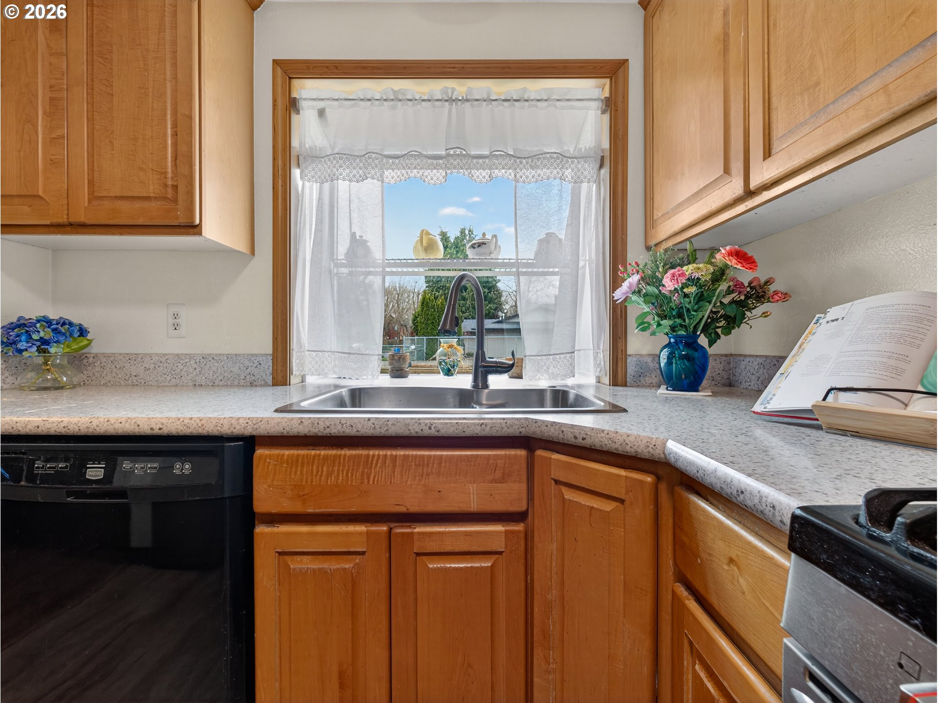3025 Northeast 29th Street Gresham, OR 97030 - Photo 10 of 33 a kitchen with stainless steel appliances granite countertop a sink and wooden cabinets