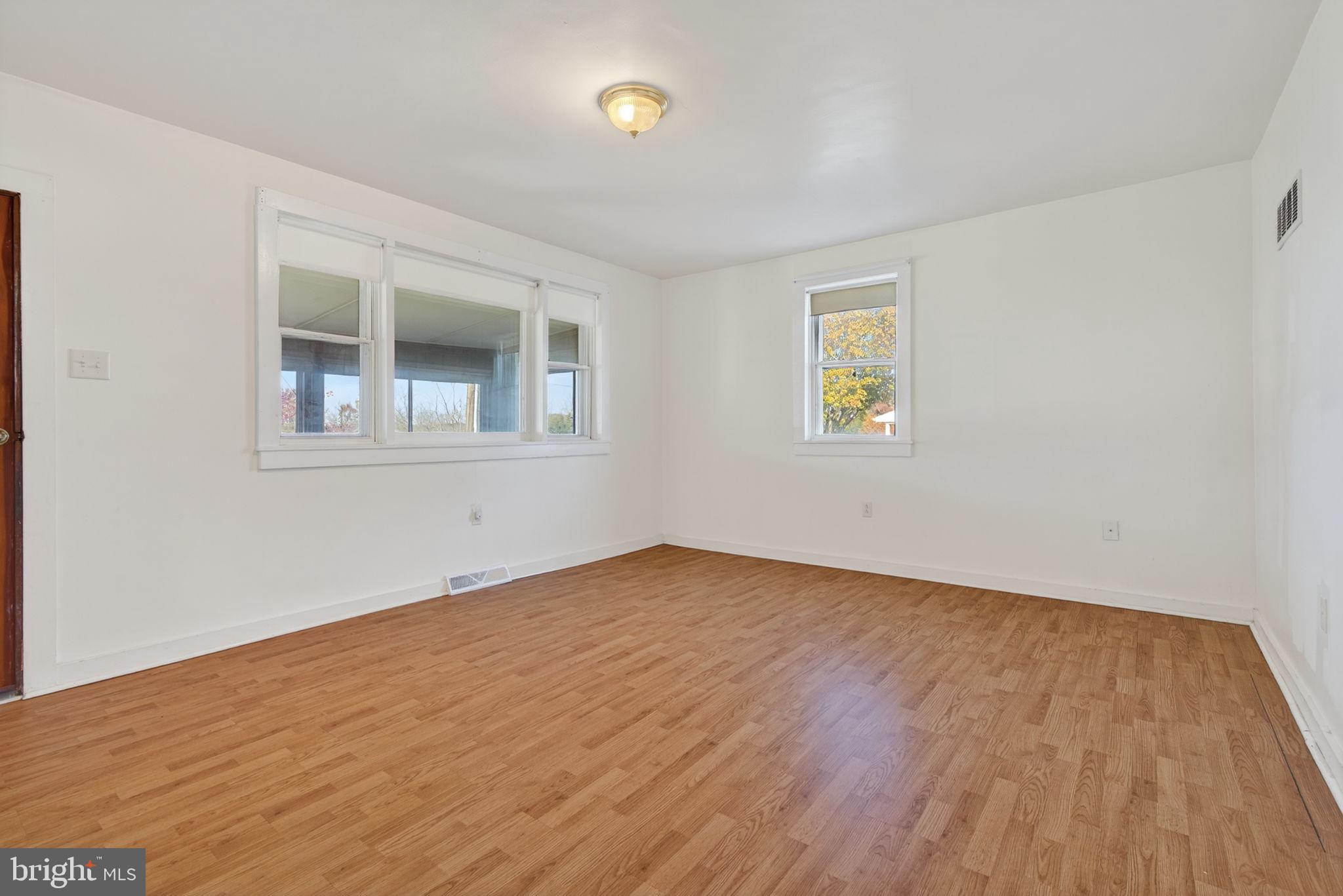 1705 Virginia Avenue Dover, PA 17315 - Photo 11 of 41 an empty room with wooden floor and windows